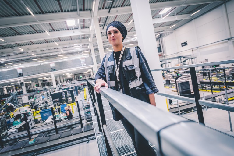 employee_holding_railing_in_warehouse.jpg